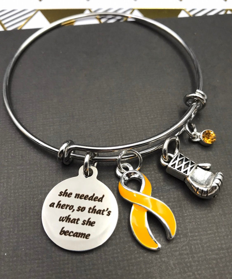 Gold Ribbon Bracelet - She Needed a Hero, So That's What She Became - Rock Your Cause Jewelry