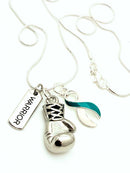 Teal and white ribbon boxing glove necklace by Rock Your Cause Jewelry, featuring a detailed boxing glove pendant with ribbon accents.