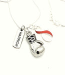 Red and white ribbon boxing glove and warrior necklace from Rock Your Cause Jewelry, displayed on a neutral background.