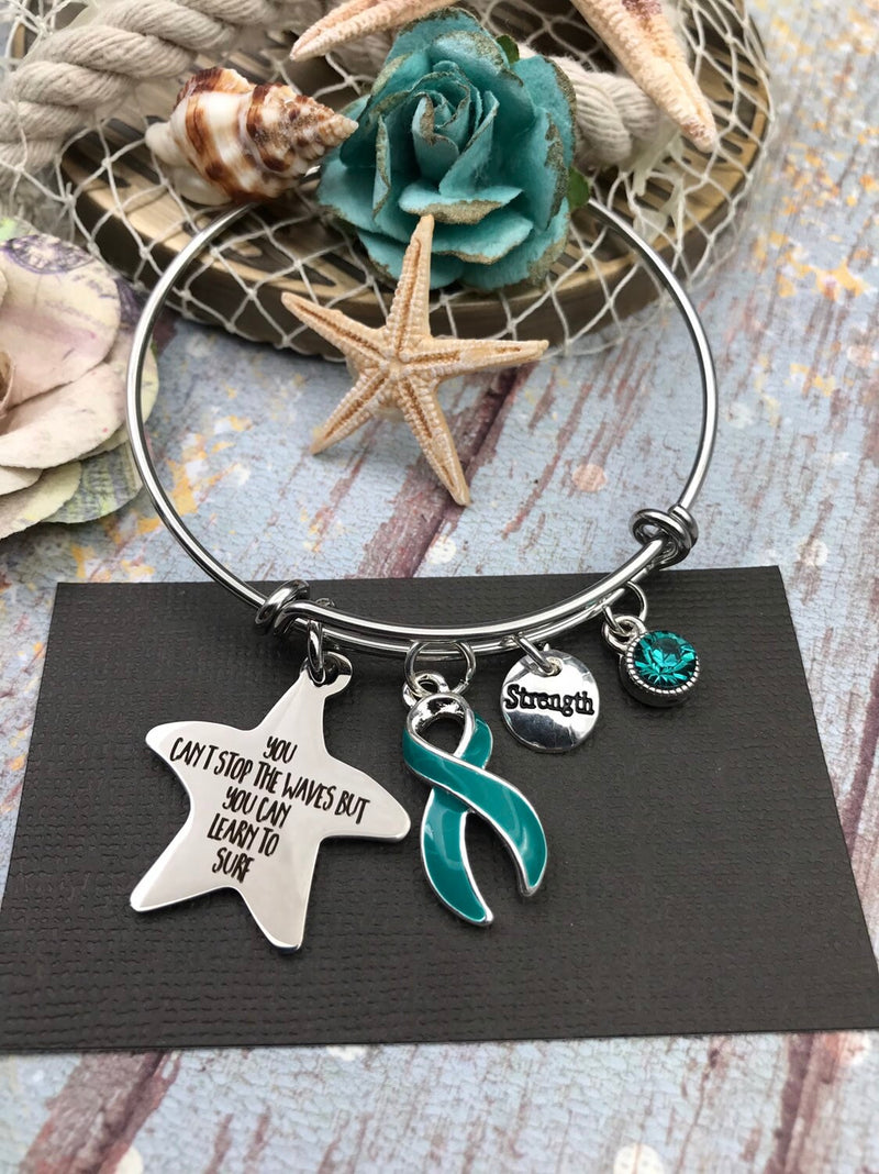 Teal Ribbon Charm Bracelet You Can't Stop The Waves, But You Can Learn To Surf - Rock Your Cause Jewelry