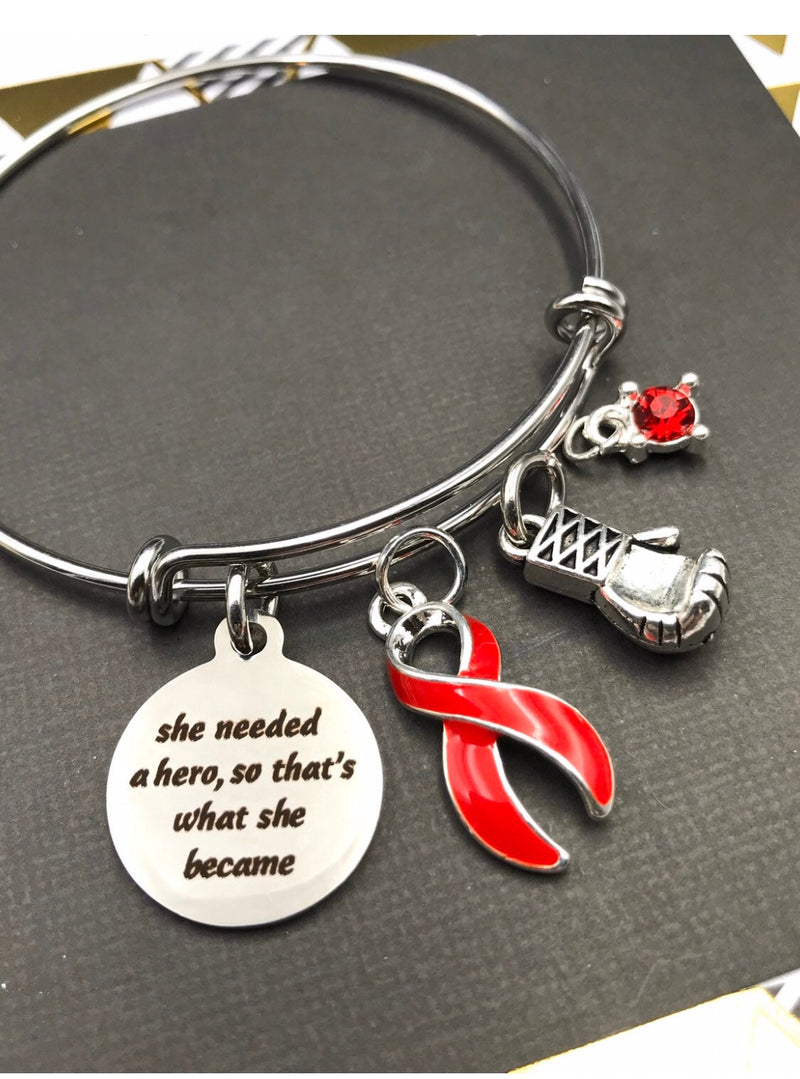 Red Ribbon Charm Bracelet - She Needed a Hero So That's What She Became - Rock Your Cause Jewelry