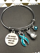 Teal Ribbon Charm Bracelet - She Needed A Hero, So That's What She Became - Rock Your Cause Jewelry